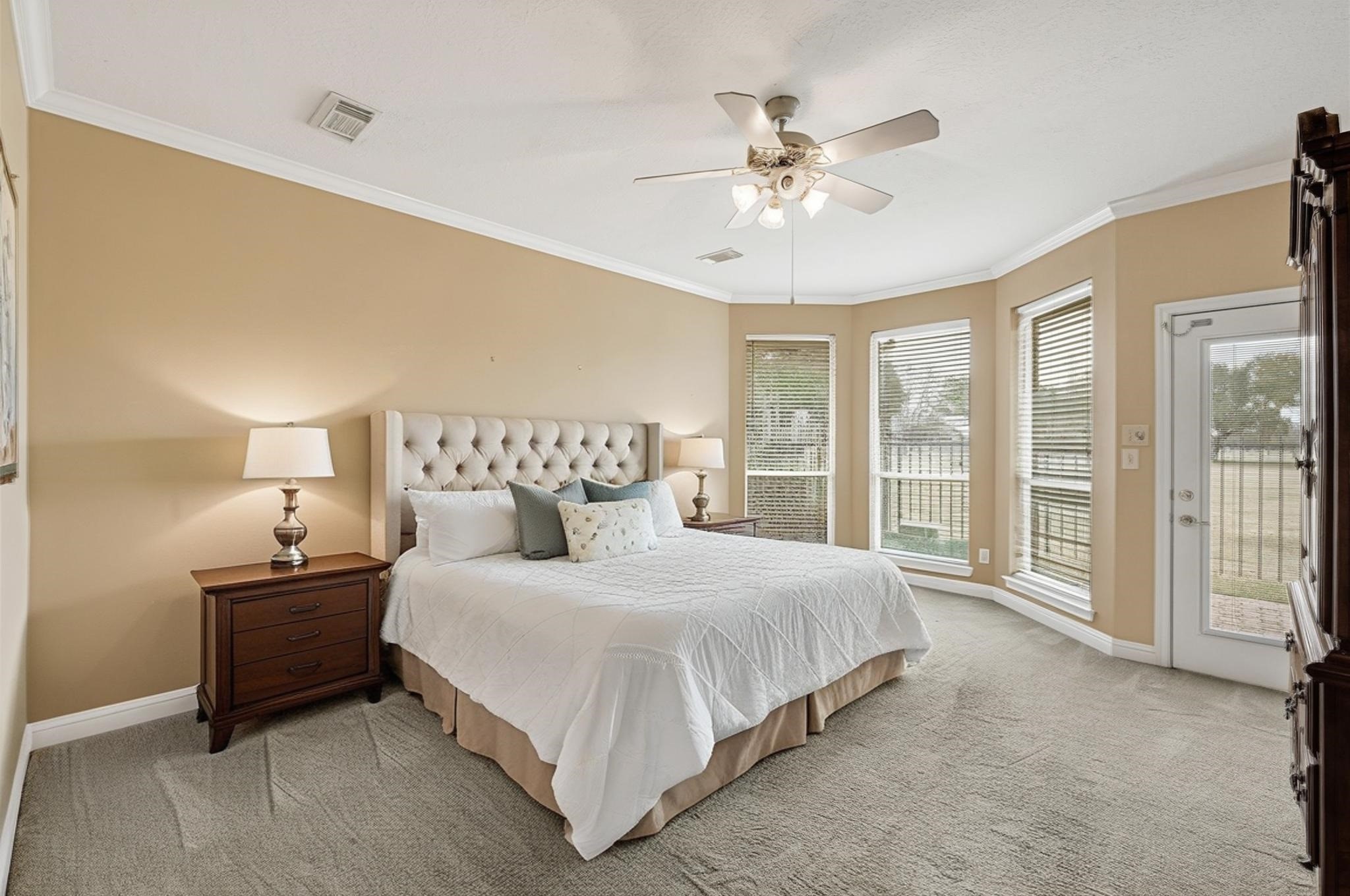35 Parkway Place Houston, TX 77040 - Photo 20 of 37 a bedroom with a large bed and a chandelier