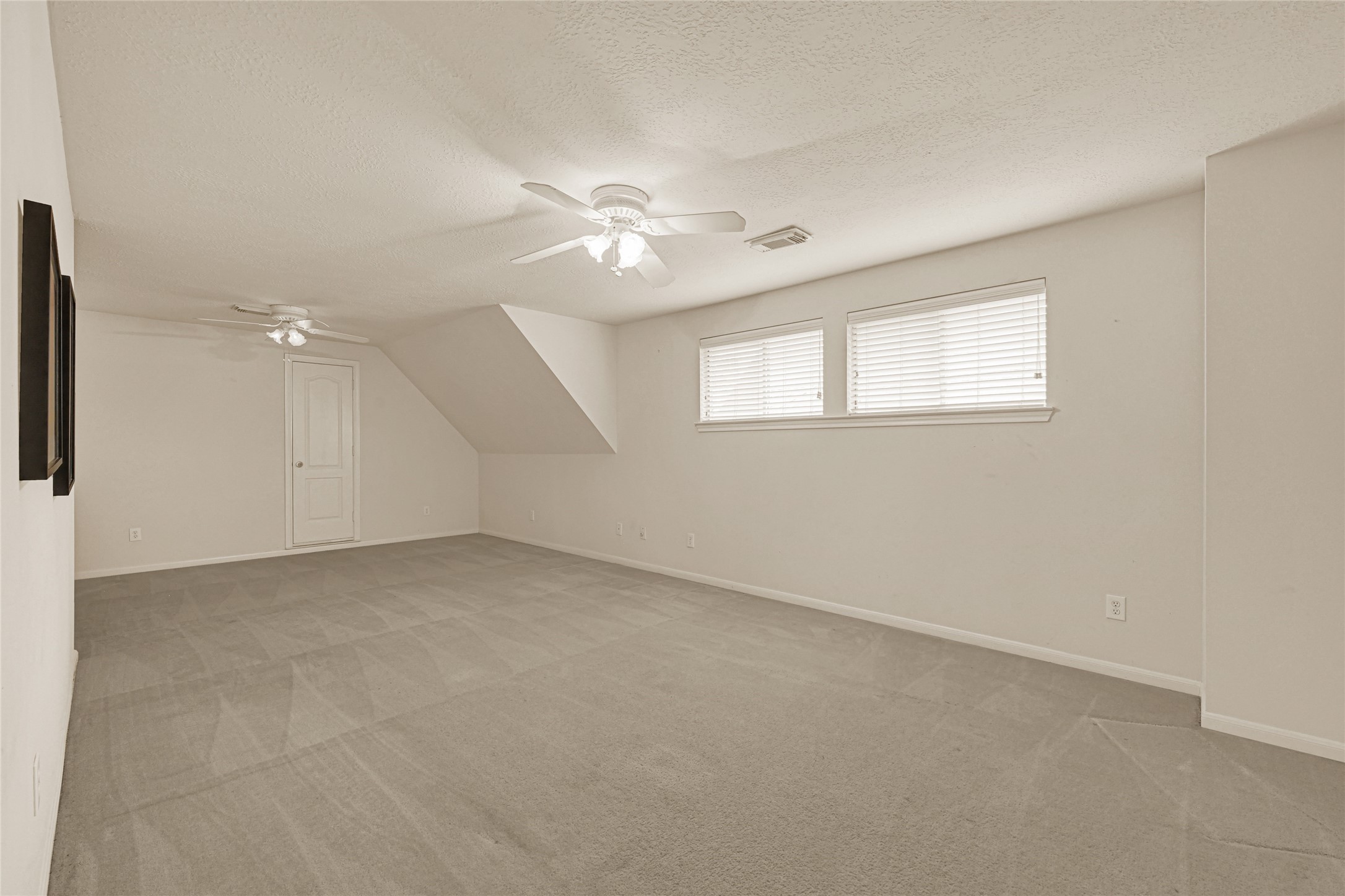 35 Parkway Place Houston, TX 77040 - Photo 27 of 37 an empty room with chandelier fan and windows