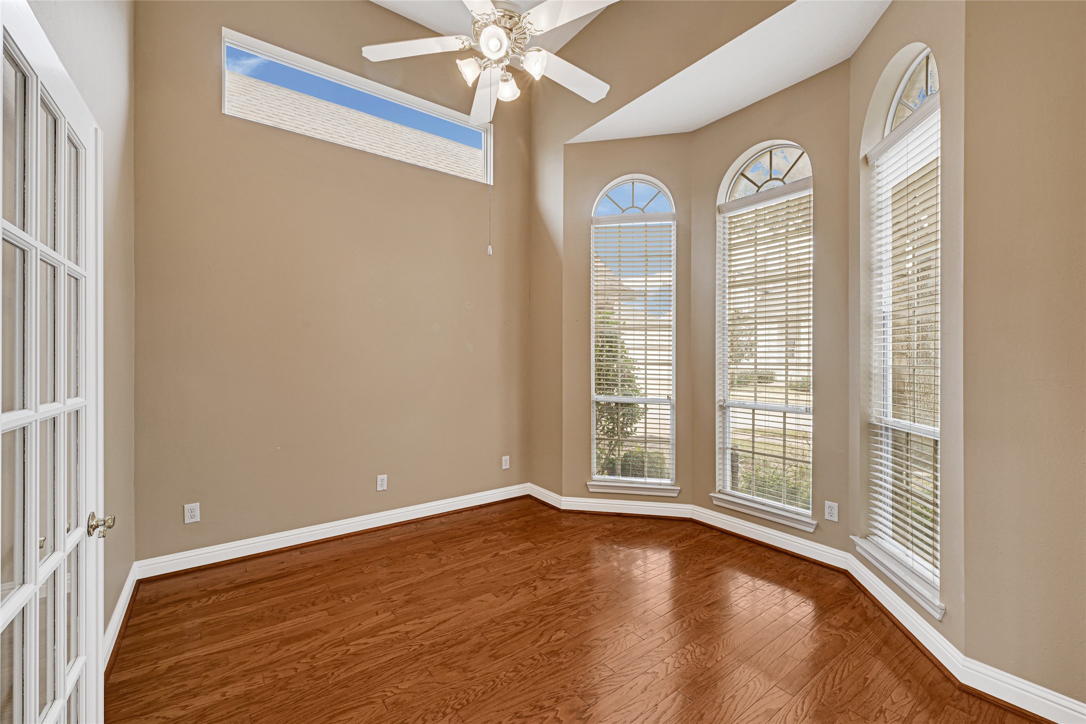 35 Parkway Place Houston, TX 77040 - Photo 6 of 37 an empty room with wooden floor fan and windows