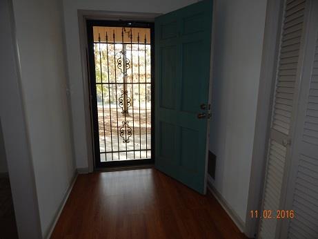 1116 Fall River Road Lawrenceburg, TN 38464 - Photo 4 of 16 a view of an empty room with wooden floor and a window