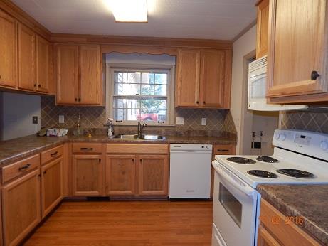 1116 Fall River Road Lawrenceburg, TN 38464 - Photo 9 of 16 a kitchen with granite countertop a sink a stove and cabinets