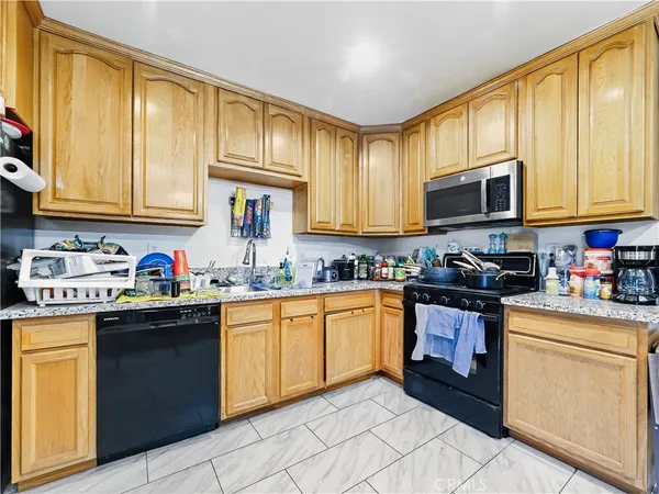 a kitchen with sink cabinets and appliances