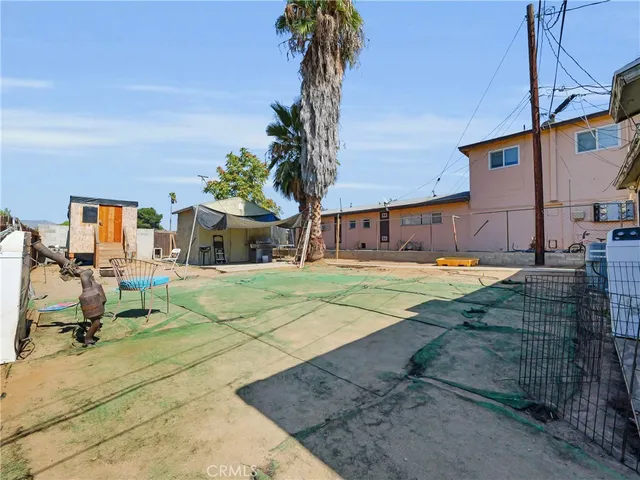 a view of a house with backyard and sitting area