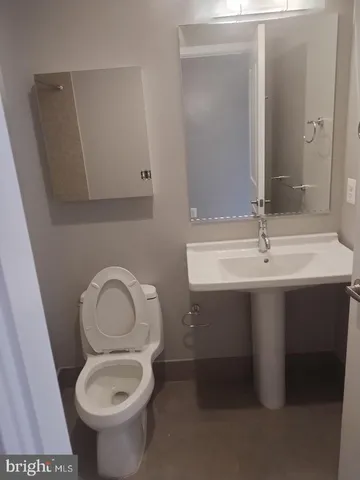 a bathroom with a sink toilet and a mirror