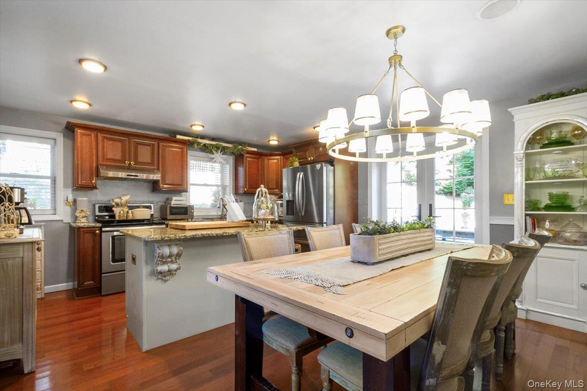 12 Philipse Road Carmel, NY 10512 - Photo 4 of 15 a kitchen with stainless steel appliances kitchen island granite countertop a kitchen island a stove a table and chairs in it