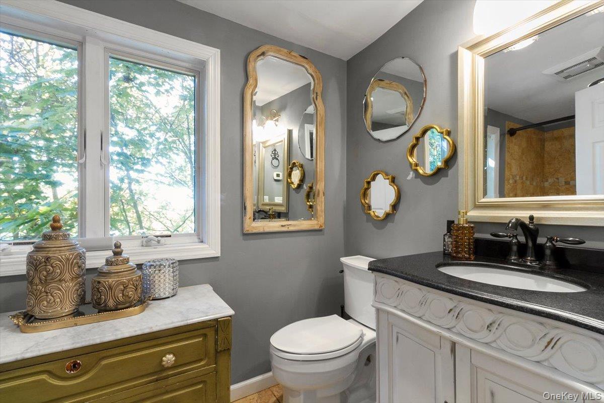 12 Philipse Road Carmel, NY 10512 - Photo 9 of 15 a bathroom with a granite countertop toilet sink and mirror