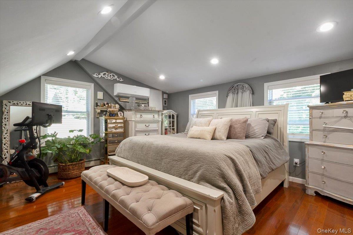 12 Philipse Road Carmel, NY 10512 - Photo 10 of 15 a spacious bedroom with a bed a couch and a flat screen tv