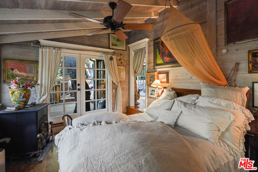 21658 Encina Road Topanga, CA 90290 - Photo 17 of 53 a bed sitting in a bedroom next to a window