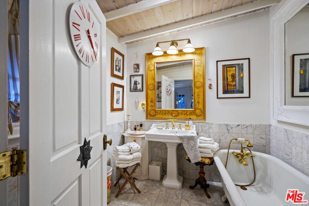 21658 Encina Road Topanga, CA 90290 - Photo 19 of 53 a bathroom with a sink a mirror and a window