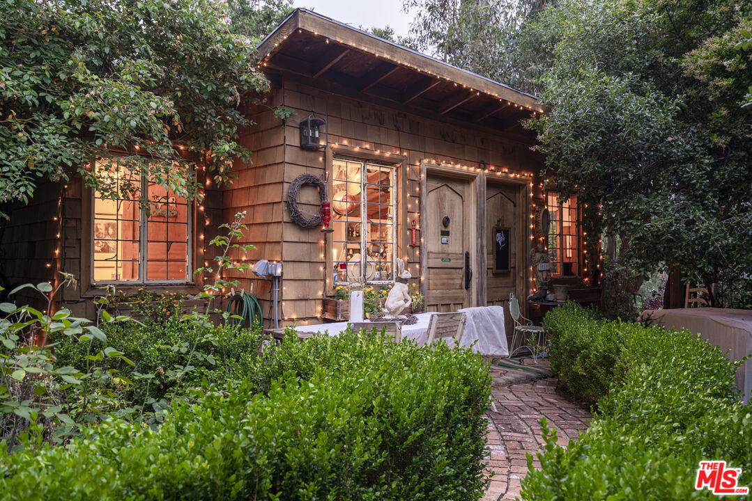 21658 Encina Road Topanga, CA 90290 - Photo 27 of 53 a view of a patio with table and chairs and potted plants
