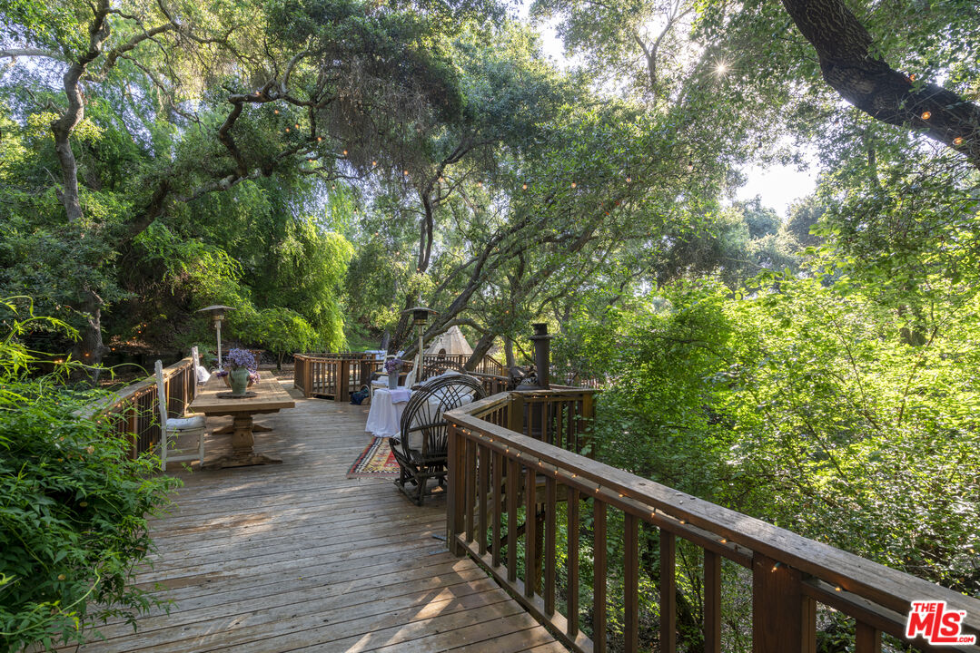 21658 Encina Road Topanga, CA 90290 - Photo 32 of 53 a view of a deck with chairs and couches