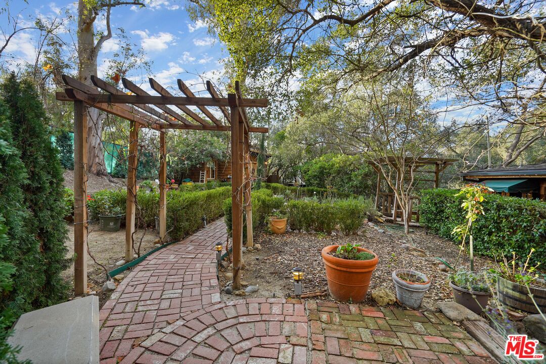 21658 Encina Road Topanga, CA 90290 - Photo 35 of 53 a view of a backyard with garden and patio