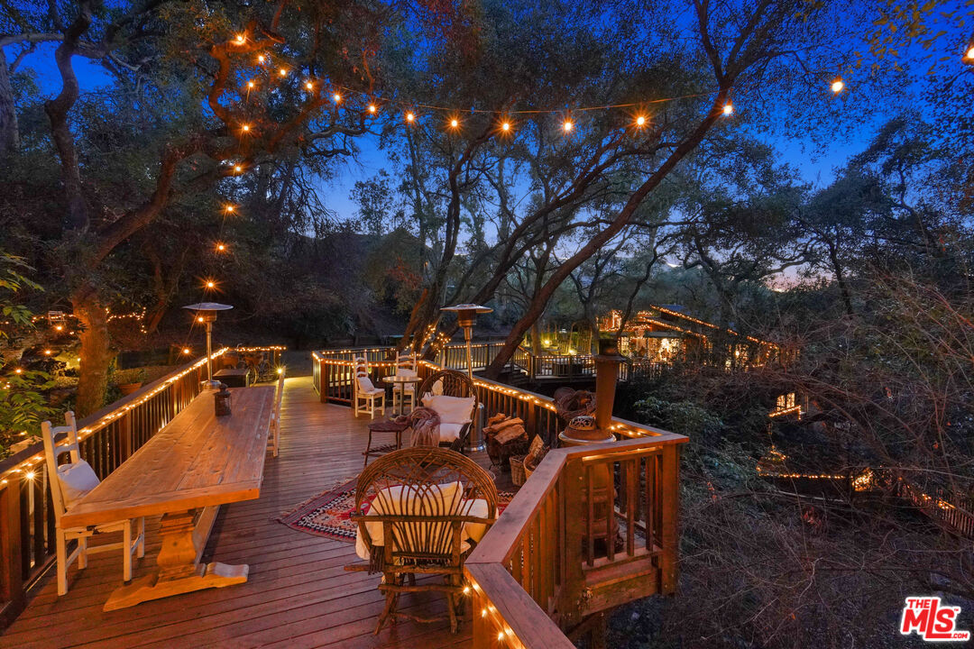 21658 Encina Road Topanga, CA 90290 - Photo 51 of 53 a view of a patio with table and chairs with wooden floor and fence