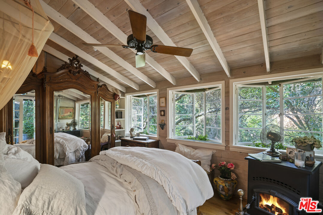 21658 Encina Road Topanga, CA 90290 - Photo 6 of 53 a bedroom with a large bed and large windows