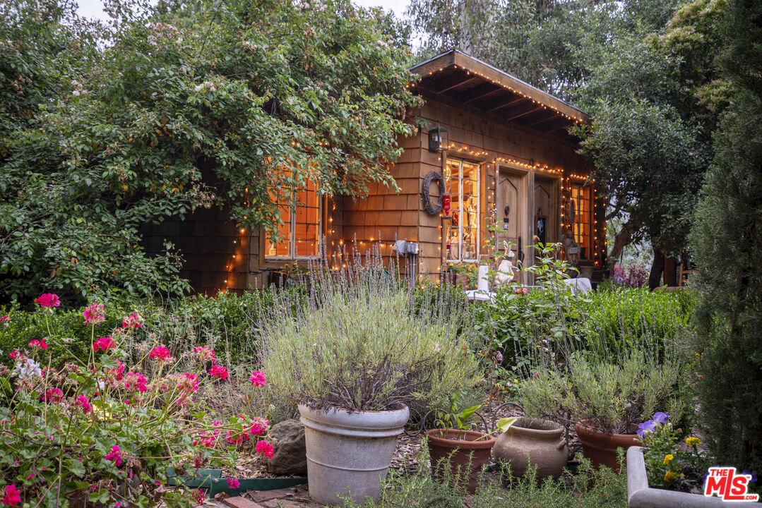21658 Encina Road Topanga, CA 90290 - Photo 7 of 53 a view of a flower garden in front of a house