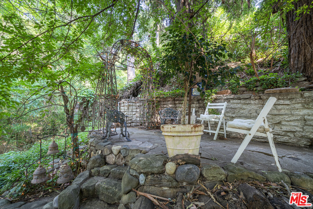 21658 Encina Road Topanga, CA 90290 - Photo 10 of 53 a view of a patio with table and chairs and potted plants