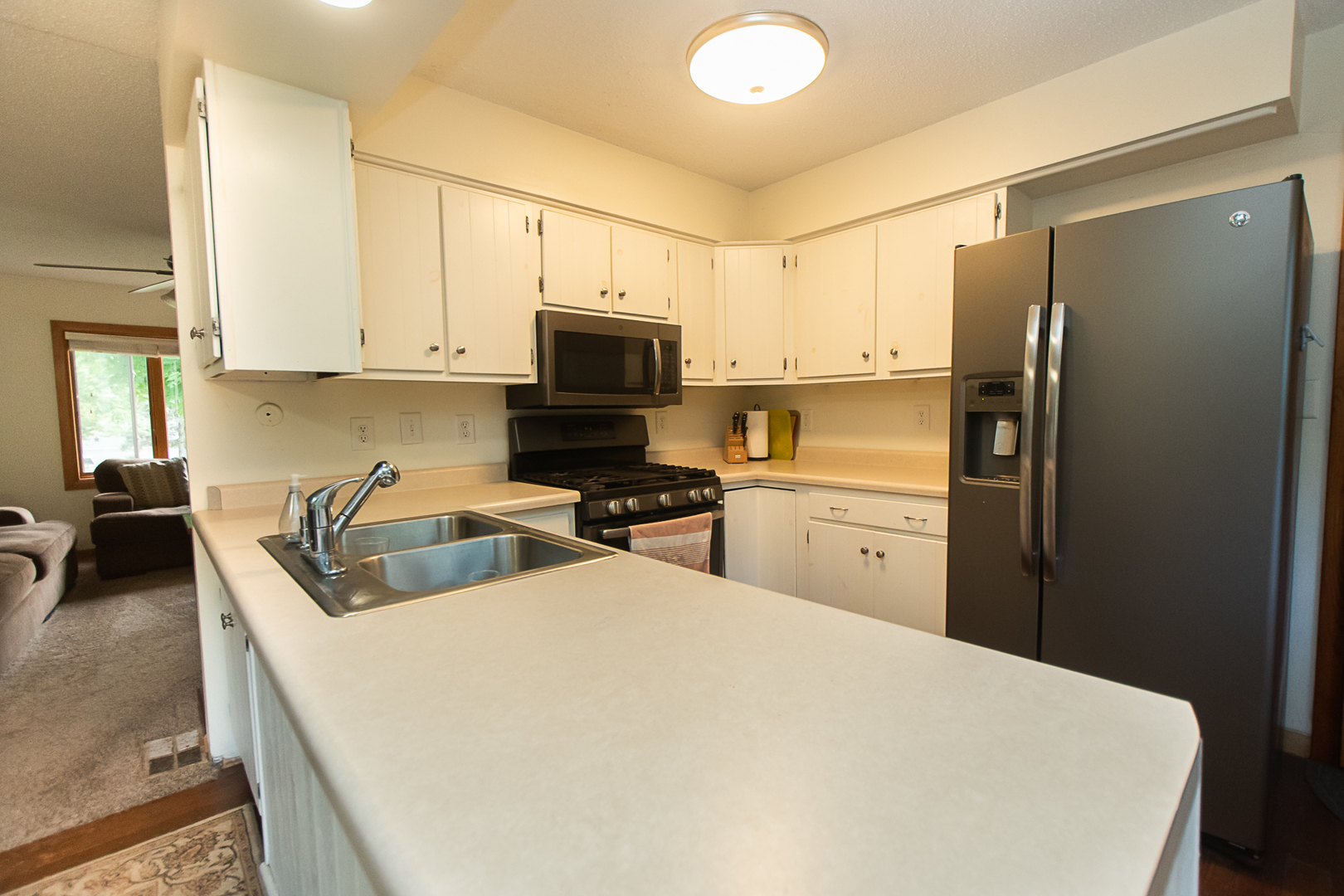 7830 Renee Rue Dixon, IL 61021 - Photo 8 of 25 a kitchen with stainless steel appliances a refrigerator sink and white cabinets