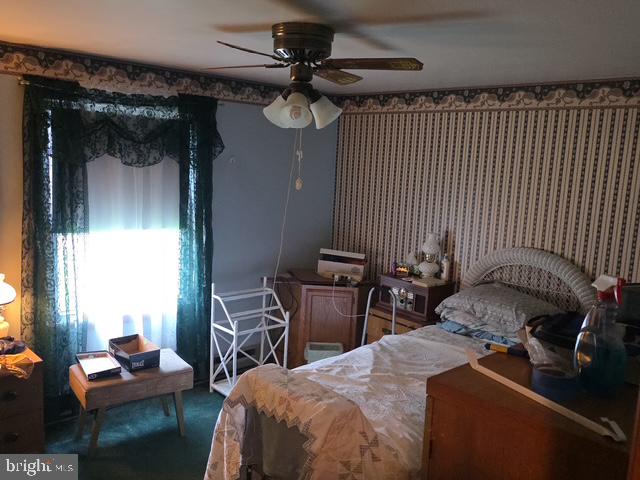 100 Mill Street Trout Run, PA 17771 - Photo 12 of 17 a bedroom with a bed and a chandelier