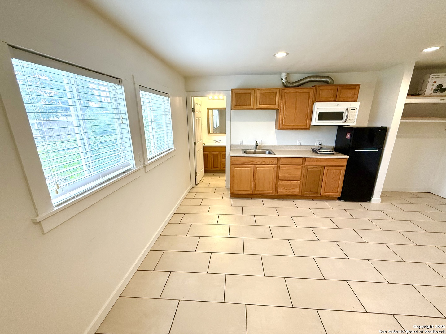 2614 Monterey Street, Unit 5 San Antonio, TX 78207 - Photo 7 of 12 a kitchen with stainless steel appliances a sink a stove a microwave a counter top space and cabinets
