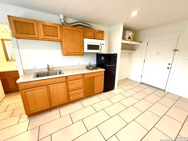 a kitchen with stainless steel appliances a sink and a refrigerator