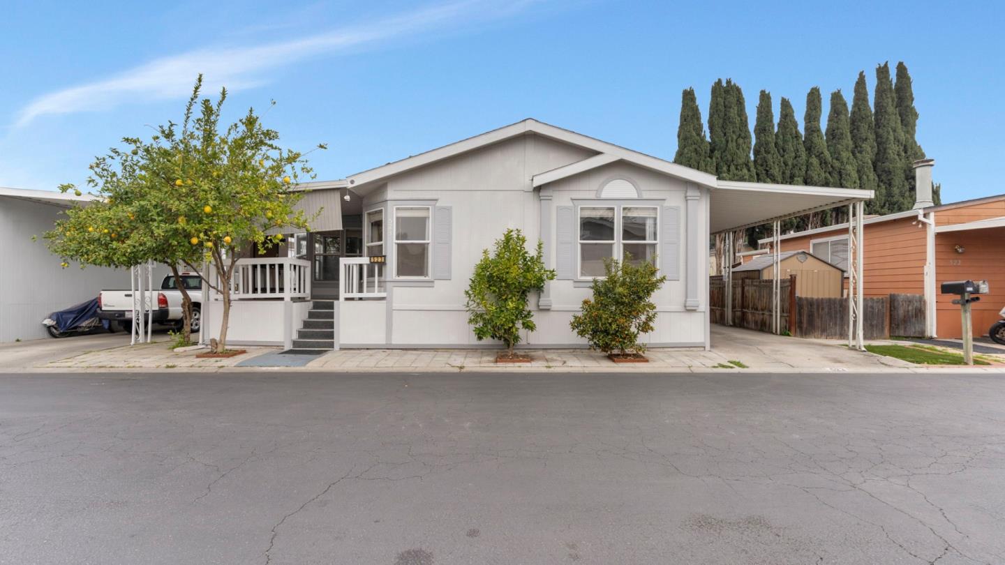 a view of a house and a yard and a street