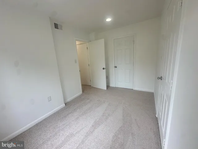 a bathroom with a toilet a sink and a mirror