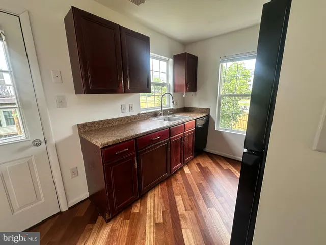 a kitchen with a sink appliances and a window