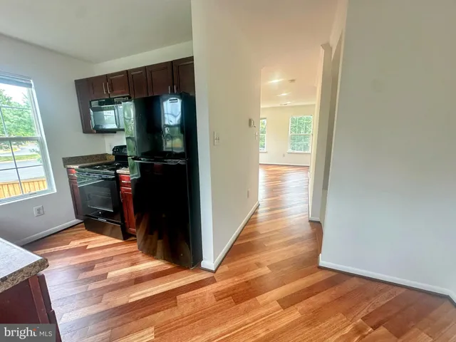 a view of room with window and wooden floor