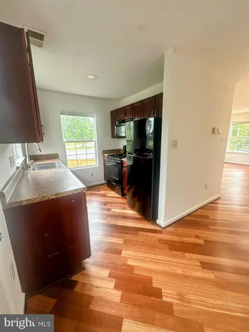 a view of room with window and hardwood floor