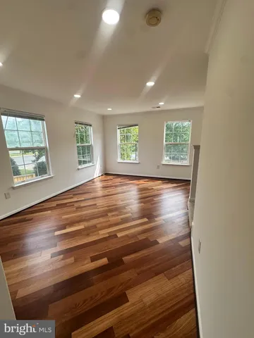a view of a room with wooden floor and chair