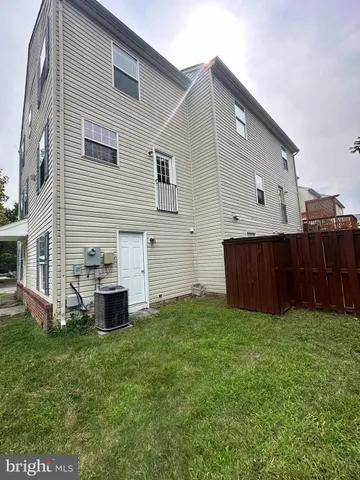 a view of a backyard with a house and large trees