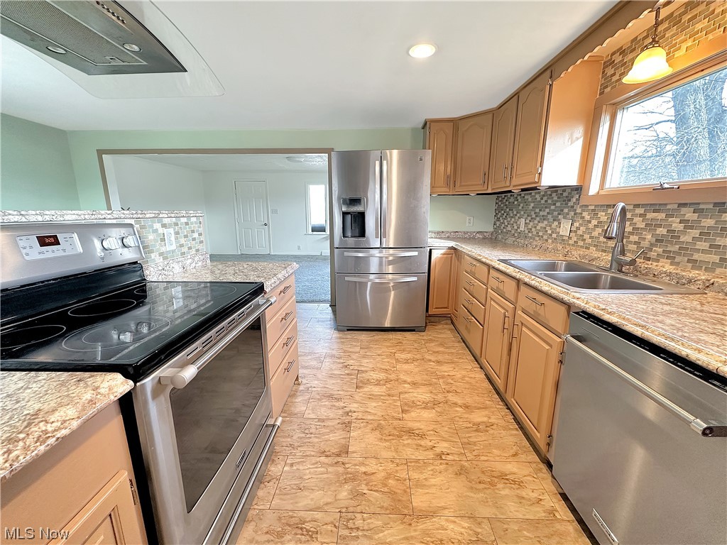 2692 Race Track Road New Cumberland, WV 26047 - Photo 9 of 25 Kitchen with hanging light fixtures, appliances with stainless steel finishes, light tile floors, sink, and tasteful backsplash