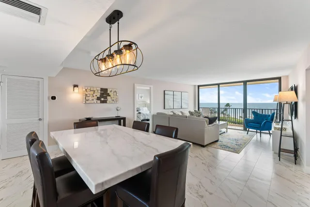 a view of a dining room with furniture wooden floor and chandelier