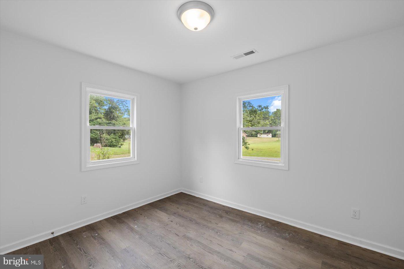 17287 Oakshade Road Orange, VA 22960 - Photo 15 of 26 a view of an empty room with wooden floor and a window