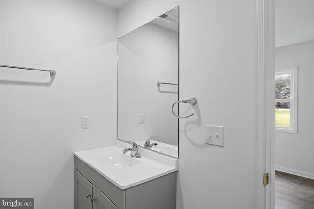 a bathroom with a sink and mirror