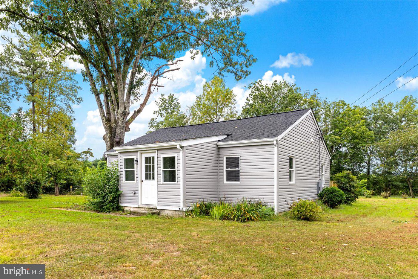 17287 Oakshade Road Orange, VA 22960 - Photo 20 of 26 a white house that has a tree in front of it