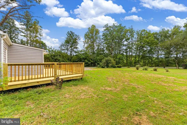 a view of a yard with wooden fence