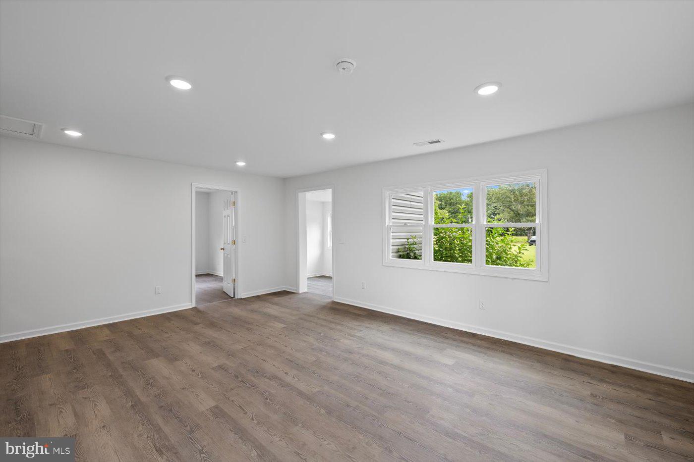 17287 Oakshade Road Orange, VA 22960 - Photo 5 of 26 an empty room with wooden floor and windows