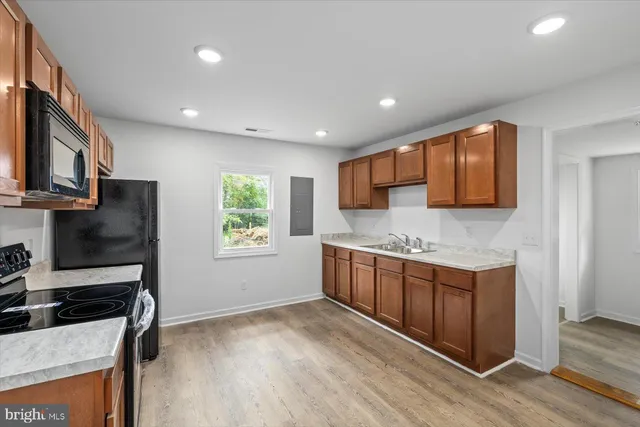 a kitchen with stainless steel appliances granite countertop a stove a sink and a refrigerator