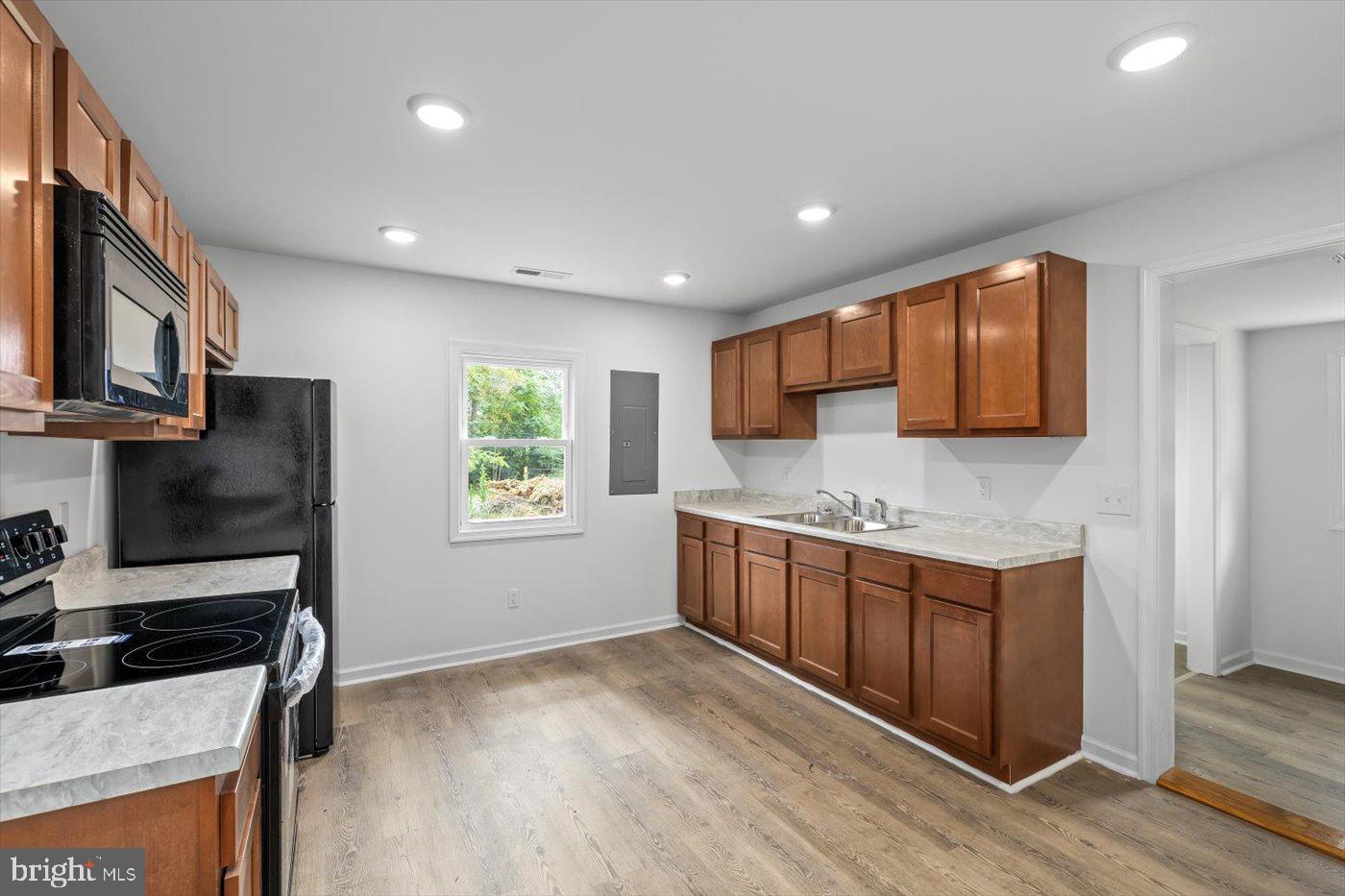 17287 Oakshade Road Orange, VA 22960 - Photo 6 of 26 a kitchen with stainless steel appliances granite countertop a stove a sink and a refrigerator