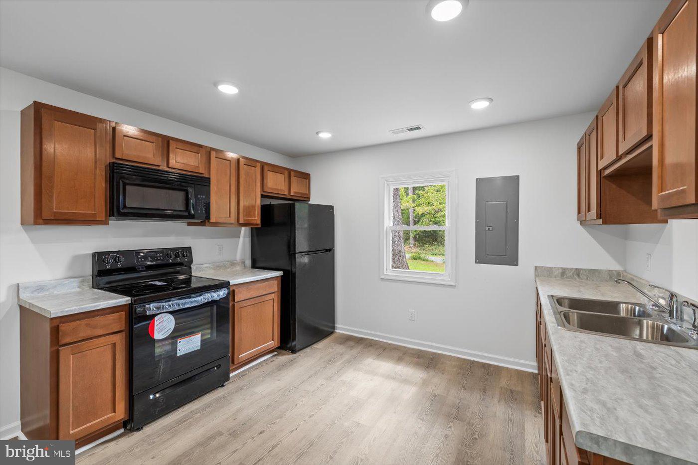 17287 Oakshade Road Orange, VA 22960 - Photo 7 of 26 a kitchen with stainless steel appliances granite countertop a stove a sink a refrigerator a microwave oven with granite countertops and cabinets