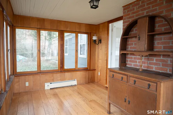 a view of a kitchen with a sink and wooden floor