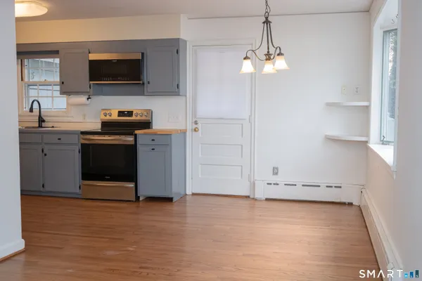 a kitchen with stainless steel appliances granite countertop a stove and a microwave