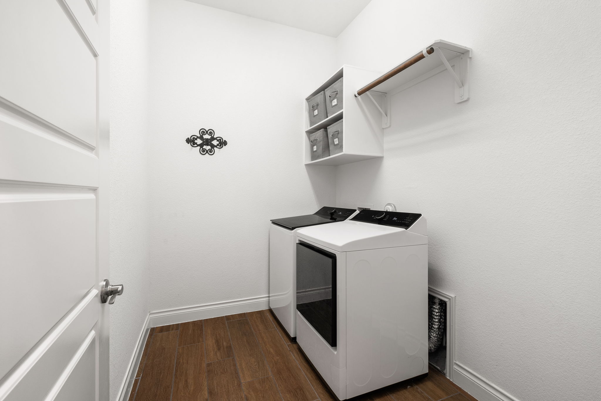 1908 Woolsey Way Leander, TX 78641 - Photo 21 of 36 A dedicated laundry room featuring convenient shelving with a hanging rod.