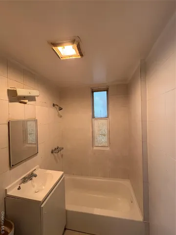 a bathroom with a shower and a tub