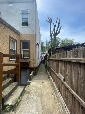 a view of a house with a yard and tree