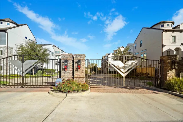 a view of a park with iron fence