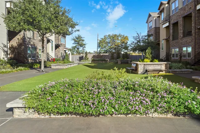 a garden with trees in the background