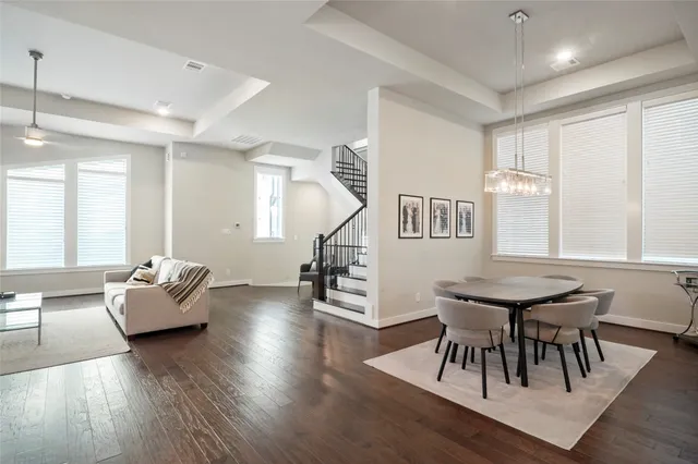 a dining room with furniture and wooden floor