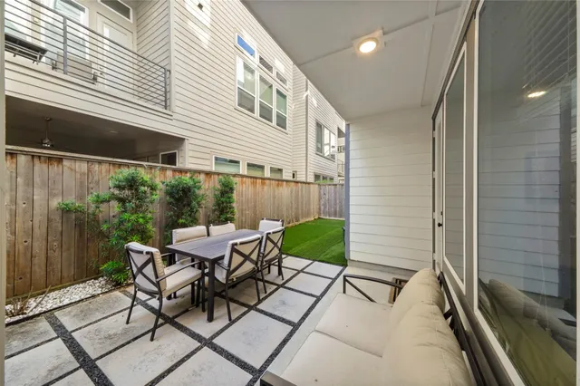 a view of a patio with table and chairs and potted plants